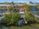 Waterfront home featuring a backyard with a dock, lush greenery, and a serene setting on Apollo Beach at 6411 Grenada Island Ave, Apollo Beach, FL 33572