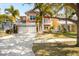 Beautiful two-story home featuring a two-car garage, well-manicured lawn, and tropical palm trees at 6411 Grenada Island Ave, Apollo Beach, FL 33572