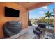 Outdoor patio area with a TV, grill, and seating with a view of the pool at 6411 Grenada Island Ave, Apollo Beach, FL 33572