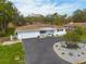 Aerial view of a well-maintained white home with a circular driveway at 6655 Colony S Dr, St Petersburg, FL 33705