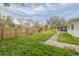 Expansive backyard featuring a wood fence, and a screened-in porch at 6655 Colony S Dr, St Petersburg, FL 33705