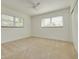 Bedroom with neutral carpeting, white walls, and two windows at 6655 Colony S Dr, St Petersburg, FL 33705