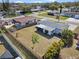 Backyard aerial view showcasing a spacious, fenced yard with mature trees and landscaping at 6681 32Nd N Ave, St Petersburg, FL 33710