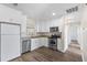 Modern kitchen featuring white cabinets, stainless steel appliances, and granite countertops at 6681 32Nd N Ave, St Petersburg, FL 33710