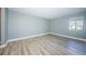 This bedroom features neutral paint, new floors, and a window for natural light at 722 116Th Ave N # 2002, St Petersburg, FL 33716