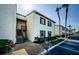 Inviting condo exterior with brown shutters, lush landscaping, palm trees and parking in front of the building at 722 116Th Ave N # 2002, St Petersburg, FL 33716