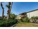 Exterior view showcasing lush landscaping, palm trees, and a private balcony at 722 116Th Ave N # 2002, St Petersburg, FL 33716