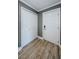 Bright condo hallway with modern gray walls, laminate wood flooring, and white interior doors at 722 116Th Ave N # 2002, St Petersburg, FL 33716