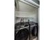 Laundry room featuring a modern washer and dryer with overhead shelving at 722 116Th Ave N # 2002, St Petersburg, FL 33716