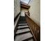 Condo outdoor staircase with stone stairs and stained wood railing leading to upper units at 722 116Th Ave N # 2002, St Petersburg, FL 33716