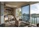 Balcony with a waterfront view featuring cozy seating, natural light and additional storage at 7465 Bay Island S Dr # 318, South Pasadena, FL 33707