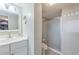 Bright bathroom featuring a white vanity with a large mirror and a glass-enclosed shower at 7465 Bay Island S Dr # 318, South Pasadena, FL 33707