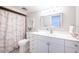 Bathroom features a clean, bright aesthetic with white vanity, leaf-patterned shower curtain, and modern fixtures at 7465 Bay Island S Dr # 318, South Pasadena, FL 33707