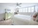 Bright bedroom with a full size bed, light wood floors, and a green dresser at 7465 Bay Island S Dr # 318, South Pasadena, FL 33707