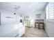 Bright bedroom with a ceiling fan, light-colored wood floors, and a charming pale green dresser at 7465 Bay Island S Dr # 318, South Pasadena, FL 33707