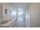 Bright hallway featuring coastal decor, storage closets, and tile flooring leading to the living areas at 7465 Bay Island S Dr # 318, South Pasadena, FL 33707