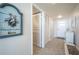 Hallway decorated with coastal-themed art, storage, and access to other rooms in the unit at 7465 Bay Island S Dr # 318, South Pasadena, FL 33707