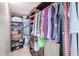 Walk-in closet with custom shelving, hanging rods, and organized storage for clothes and shoes at 7465 Bay Island S Dr # 318, South Pasadena, FL 33707