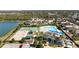 Aerial view of the community showcasing the pool, tennis courts, playground, and clubhouse at 8208 Harwich Port Ln, Gibsonton, FL 33534