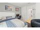 Inviting bedroom with a gray accent wall, featuring a comfortable bed, desk and beanbag chair at 8208 Harwich Port Ln, Gibsonton, FL 33534