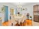 Dining area with hardwood floors and bright natural light from the sliding glass door at 8208 Harwich Port Ln, Gibsonton, FL 33534