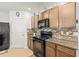 Close-up of kitchen appliances, cabinetry and tiled backsplash at 8208 Harwich Port Ln, Gibsonton, FL 33534