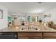 Kitchen island with double sinks and a view of the living and dining areas at 8208 Harwich Port Ln, Gibsonton, FL 33534