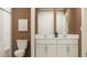 Contemporary bathroom with dual sinks, a toilet, a bathtub and a framed mirror at 8446 Bella Mar Trl, Parrish, FL 34219