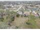 Aerial view of the home featuring a spacious yard and a fire pit area at 8547 Horizon Ln, Hudson, FL 34667