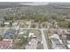 An aerial shot showcases the neighborhood and surrounding wooded area at 8547 Horizon Ln, Hudson, FL 34667