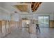 Damaged kitchen area with exposed framing, perfect for full custom rebuild and pool views through sliding doors at 8547 Horizon Ln, Hudson, FL 34667