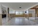 Spacious room with exposed studs for custom renovation, featuring a large window and a connection to the garage at 8547 Horizon Ln, Hudson, FL 34667