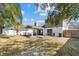 The backyard offers a covered patio, well-maintained lawn, and mature trees for shade at 8814 Hampden Dr, Tampa, FL 33626