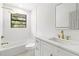 This bathroom features a sleek design with white tiles, modern fixtures, and natural light at 8814 Hampden Dr, Tampa, FL 33626