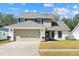 Charming two-story home featuring a well-maintained lawn and neutral two-car garage at 8814 Hampden Dr, Tampa, FL 33626