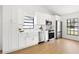 Bright kitchen featuring stainless appliances, white shaker cabinets and a farmhouse sink at 8814 Hampden Dr, Tampa, FL 33626