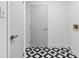 The laundry room features a stylish black-and-white tiled floor and ample storage space at 8814 Hampden Dr, Tampa, FL 33626