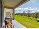 Relaxing back patio with seating and a view of the lush green yard at 9258 Rock Harbour Way, Tampa, FL 33637