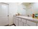 Bright bathroom featuring a double sink vanity with speckled countertop and white cabinets at 9258 Rock Harbour Way, Tampa, FL 33637