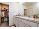 Well-lit bathroom featuring double sinks, spacious countertop and walk-in closet at 9258 Rock Harbour Way, Tampa, FL 33637