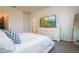 Calm bedroom featuring white bedding, blue decorative pillows and a TV on a dresser at 9258 Rock Harbour Way, Tampa, FL 33637