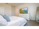 Calm bedroom featuring white bedding, blue decorative pillows and a TV on a dresser at 9258 Rock Harbour Way, Tampa, FL 33637