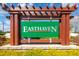 Charming entrance to the Easthaven community framed by a beautiful wooden structure with stone and lush greenery at 9258 Rock Harbour Way, Tampa, FL 33637