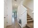 Bright hallway with neutral tile flooring and staircase leading to the upper level at 9258 Rock Harbour Way, Tampa, FL 33637