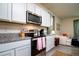 Well-lit kitchen featuring stainless steel appliances, granite countertops, and white cabinets at 9258 Rock Harbour Way, Tampa, FL 33637