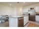 Kitchen featuring a central island with granite countertop, stainless steel dishwasher, and refrigerator at 9258 Rock Harbour Way, Tampa, FL 33637