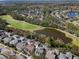 Aerial view of homes located near a lush golf course and a serene lake at 9510 Georgian Park Ln # 106, Tampa, FL 33626