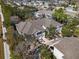 An aerial view of a row of townhomes, showcasing the neutral exterior color, rooflines, and mature trees at 9510 Georgian Park Ln # 106, Tampa, FL 33626