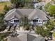 Aerial view of townhomes featuring gray roofs, manicured lawns, and mature trees at 9510 Georgian Park Ln # 106, Tampa, FL 33626