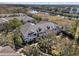 Aerial view of townhomes backing onto a pond surrounded by mature trees and landscaping at 9510 Georgian Park Ln # 106, Tampa, FL 33626